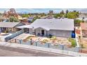 Charming single story home with desert landscaping, white paint and grey trim, palm trees, and mountain views at 1112 Sandy Cove St, Las Vegas, NV 89110