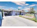 Single story home featuring a long driveway, desert landscaping, and a covered area for parking at 1112 Sandy Cove St, Las Vegas, NV 89110