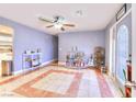 Inviting living room with tiled floors, ceiling fan, and a charming bar area for entertaining at 1112 Sandy Cove St, Las Vegas, NV 89110