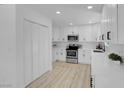 Bright, updated kitchen with white cabinets, stainless steel appliances, and recessed lighting at 1115 W Nelson Ave, North Las Vegas, NV 89030