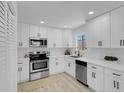 Bright kitchen features white cabinets, stainless steel appliances, and modern countertops at 1115 W Nelson Ave, North Las Vegas, NV 89030
