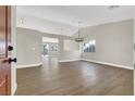 Bright and spacious living room with wood-look floors and modern lighting fixtures at 1225 Stonesthrow Cir, North Las Vegas, NV 89031