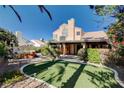 Secluded backyard featuring a spa, lush greenery, and a covered patio at 1333 Date Palm Cir, Las Vegas, NV 89108