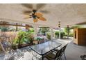 Covered patio with a ceiling fan and dining table, perfect for outdoor entertaining at 1333 Date Palm Cir, Las Vegas, NV 89108