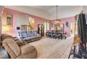 Open-concept living room and dining area with plush furniture and ample natural light at 1333 Date Palm Cir, Las Vegas, NV 89108