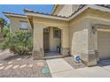 Close up of the home's entrance featuring a secure door and landscaping at 1701 Drifters Peak St, Las Vegas, NV 89144