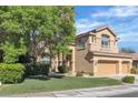 Charming two-story home with landscaped yard and a three-car garage at 1717 Double Arch Ct, Las Vegas, NV 89128