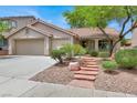 Well-maintained single-story home with a two-car garage and attractive desert landscaping at 209 Prairie Creek St, Henderson, NV 89012