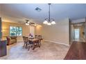 Spacious dining room with tile floors, chandelier, and natural light at 2189 De Narvik Dr, Henderson, NV 89044