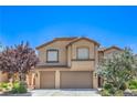 Charming two-story home with tile roof, two-car garage, and professionally landscaped yard at 2189 De Narvik Dr, Henderson, NV 89044