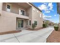 Side view of home highlighting exterior siding, windows, balcony, and long driveway at 2231 Desert Prairie St, Las Vegas, NV 89135