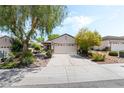 Charming single-story home featuring mature landscaping and a two-car garage at 2326 Garnet Star St, Henderson, NV 89044