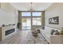 Bright living room boasts a modern fireplace, contemporary furnishings, and access to the pool area at 2714 Langlade Ave, Henderson, NV 89052