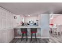 Kitchen boasts white cabinets and appliances, breakfast bar and dining area with pink accent wall at 2725 S Nellis Blvd # 1038, Las Vegas, NV 89121