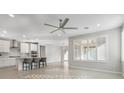 Open-concept living space with a view of the modern kitchen and backyard access at 2771 Free Formed Ct, Las Vegas, NV 89138