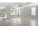 Spacious living room featuring tile flooring and large windows with plantation shutters at 2771 Free Formed Ct, Las Vegas, NV 89138