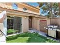 Private back patio with artificial turf, grill, and door leading to the interior at 2830 Crystal Lantern Dr, Henderson, NV 89074