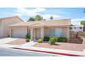 Well-maintained home featuring a tile roof, desert landscaping, and a two-car garage, situated on a quiet street at 2859 Palleta Dr, Henderson, NV 89074