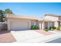 Attractive home featuring a tile roof, desert landscaping, a two-car garage, and a welcoming covered entrance at 2859 Palleta Dr, Henderson, NV 89074