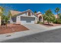 Inviting single-Gathering home with a two-car garage, desert landscaping, and mature tree at 2904 Channel Bay Dr, Las Vegas, NV 89128