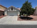 Inviting single-Gathering house with a two-car garage, tile roof and desert landscaping offers timeless curb appeal at 2904 Channel Bay Dr, Las Vegas, NV 89128