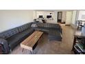 Comfortable living room with a large sectional sofa, coffee table, and tiled floors at 2989 Bel Air Dr, Las Vegas, NV 89109