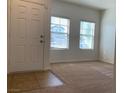 Light and bright entryway with neutral carpet, tile entry and large windows at 3728 Prairie Orchid Ave, North Las Vegas, NV 89081