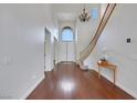 Bright entryway featuring hardwood floors, a staircase, and a grand window above double front doors at 3728 White Lion Ln, North Las Vegas, NV 89084
