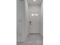 White door and tile entryway with minimalist design and neutral tones at 4448 Mahogany Hills Ave, Las Vegas, NV 89141