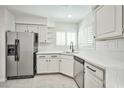 Well-lit kitchen with stainless steel appliances, white cabinets, and ample counter space at 5316 Fieldstone Rd, Las Vegas, NV 89107