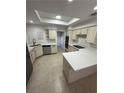 Spacious kitchen with an island, skylight, stainless steel appliances, and white cabinets at 5316 Fieldstone Rd, Las Vegas, NV 89107