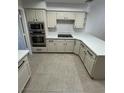 Kitchen with white cabinets, stainless steel appliances, countertops and tile flooring at 5316 Fieldstone Rd, Las Vegas, NV 89107