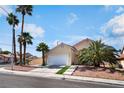 Charming two-story home featuring a two-car garage and mature palm trees at 5516 Cory Pl, Las Vegas, NV 89107