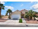 Inviting two-story home with a two-car garage, palm trees, and xeriscaping at 5516 Cory Pl, Las Vegas, NV 89107