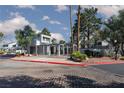 Community entrance gate with mature trees and landscaping, and a brick-paved street at 5523 Orchard Ln # 0, Las Vegas, NV 89110