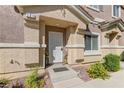 Inviting front entrance featuring a decorative security door and well-maintained landscaping at 5552 Dueces Wild Ct # 101, Las Vegas, NV 89122