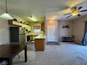 Open floor plan with a ceiling fan, dining area and kitchen views at 5750 E Hacienda Ave # 107, Las Vegas, NV 89122