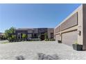 This single story home features a long paver driveway leading up to a three car garage at 6845 Hidden Sunset Ln, Las Vegas, NV 89120