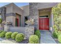 Paver walkway leads up to the red front door of this single story home at 6845 Hidden Sunset Ln, Las Vegas, NV 89120