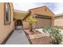 Cozy front entrance featuring a pergola, desert landscaping, and tiled walkway at 6929 Homing Pigeon Pl, North Las Vegas, NV 89084