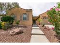 Charming single-story home featuring a landscaped front yard with desert plants and bushes at 6929 Homing Pigeon Pl, North Las Vegas, NV 89084