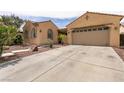 Inviting single-story home with desert landscaping and a spacious two car driveway at 6929 Homing Pigeon Pl, North Las Vegas, NV 89084