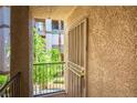 Inviting entryway with a secure screen door and a view of lush greenery at 7143 S Durango Dr # 202, Las Vegas, NV 89113