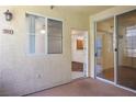 Private patio features access to the unit's interior through a sliding glass door and window at 7143 S Durango Dr # 202, Las Vegas, NV 89113