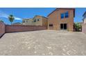 Large, empty backyard with a block wall, offering privacy and space for customization at 7464 Edgecove Ct, Las Vegas, NV 89139