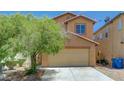 Two-story home with a two-car garage and drought-tolerant landscaping in the front yard at 7464 Edgecove Ct, Las Vegas, NV 89139
