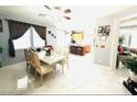 Bright dining area featuring tile floors, a ceiling fan, and natural light from large windows at 8156 Blue Hope Diamond Ln, Las Vegas, NV 89139