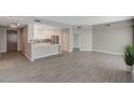 Open concept living space with views into the kitchen and gray wood tile flooring throughout at 8255 S Las Vegas Blvd # 2004, Las Vegas, NV 89123