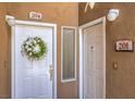 Entrance showing two white doors with gold hardware and wreaths, and marble address plates at 8737 Red Brook Dr # 204, Las Vegas, NV 89128
