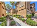 Exterior of condo showing sidewalk and desert landscaping between units in a multi-unit building at 8737 Red Brook Dr # 204, Las Vegas, NV 89128